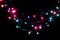 Christmas romantic decorative garland lights frame on black background with copy space