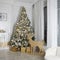 the Christmas room decoration. Spruce with gifts. Wooden figures of deer with light. Fireplace decorated with a wreath and candles