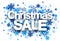 Christmas sale paper sign over snowflakes