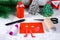 Christmas Santa Claus in chimney made from toilet paper hub, colored paper, marker, glue, fishing line and cotton pad. DIY toy on