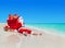 Christmas Santa Claus with gift boxes sack at tropical beach