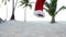 Christmas Santa Claus hat fall down on sand at the beach