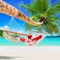 Christmas Santa Claus relax in palm shade hammock at tropical sandy ocean island beach