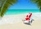 Christmas Santa Claus relax in sunlounger at tropical sandy palm beach