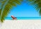 Christmas Santa Claus relaxing on sunlounger at ocean sandy tropical beach