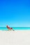 Christmas Santa Claus relaxing in sunlounger at ocean tropical b