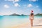 Christmas santa hat Asian girl happy relaxing walkin on winter south holidays Caribbean beach. Bikini girl on travel