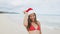 Christmas Santa hat bikini woman on beach vacation