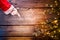 Christmas. Santa showing empty copy space on a wooden background