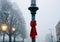 A Christmas Scarf Wrapped Around A Lamppost, In Misty Weather. Generative AI