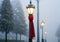 A Christmas Scarf Wrapped Around A Lamppost, In Misty Weather. Generative AI