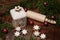 Christmas scene with cinnamon stars, rolling pin, a ceramic biscuit tin and other christmas decoration on an old wooden table