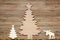 Christmas scene made of wooden decors against a wooden background