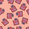 Christmas seamless pattern drawn by hand. Red gift with purple ribbon on a pink background. Happy New Year