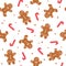 Christmas seamless pattern with gingerbread man and woman and candy canes on white background. Winter holiday theme.