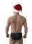 Christmas season: back of muscular man in Santa Claus red hat