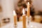 Christmas served table with yellow candles and fir tree at background.