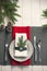 Christmas serving table. Traditional festive decoration background top view. Cutlery utensils beautiful plates decorative elements