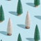 Christmas shining trees pattern, bright white and green fir on pastel blue. Winter Happy holidays