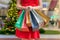 Christmas shopping concept. Woman is standing with many shopping bags