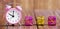 Christmas shopping, time to gift. Pink alarm clock and gift boxes, web banner