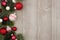 Christmas side border of red and white baubles with branches on gray wood