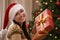 Christmas, smile and portrait of woman with present at her home for festive celebration, event or party. Excited, happy