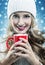 Christmas snowfall - woman holding a red mug