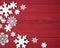 Christmas Snowflakes Decorations on the Side of  Rustic Red Wood Boards Background with looking-down view in a Horizontal crop tha