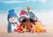 Christmas snowman, coconut glasses, flowers and starfish in the sand