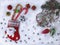 Christmas snowy background with Christmas sock, lollipops, Christmas tree toys, branches, cones.