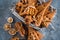 Christmas spices, gingerbread cookies and baking ingredients on grey concrete background. Cinnamon, anise stars, nutmeg, cardamon,