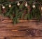 Christmas square composition with vintage garland and fir branches on wooden background. string lights.