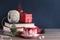 Christmas still life. A Christmas mug with marshmallows, a pile of books and a red gift