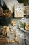 Christmas still life with present, almond, cinnamon, snowflakes on wooden table.