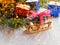 Christmas still life of a toy sled, Vintage photo, Gifts for Christmas on wooden sled, Merry Christmas tree transporter