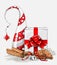 Christmas still-life, white gift box with big red ribbon, cookies, cinnamon and jingle bells and abstract chritmas tree