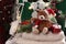 Christmas still life with wool sweaters and teddy bear in Santa hat on green chair