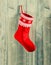 Christmas stocking. red sock with white snowflakes hanging