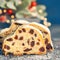 Christmas stollen on blue-green festive background with Xmas lig