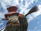 Christmas street decoration Snowman with hat and broom under the cloudy sky