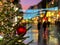 Christmas street life in the city ,green tree decorated with red balls and illumination,people walking  ,holiday travel to Medieva