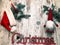 Christmas stuff: symbol, pine tree, newyear tree, santa, cone, candle, silver snowflakes on wood background