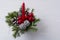 Christmas table centerpiece with red candle and silver pine cone