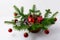 Christmas table centerpiece with red ornaments and rustic straw