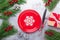 Christmas table place setting with empty red plate, cutlery with festive decorations on stone background