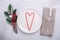 Christmas table place setting with empty white plate, candy canes, cutlery with festive decorations on stone background