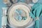 Christmas table place settings in aqua blue, silver and white