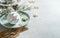Christmas table setting background with pale blue plate, golden cutlery, Christmas bauble, fir greens and decoration. Festive
