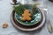 Christmas table setting. Brown-green vintage plates, vintage fork, spruce branch and ginger man, gray tablecloth